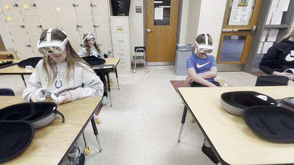 Students using VR headsets in a classroom