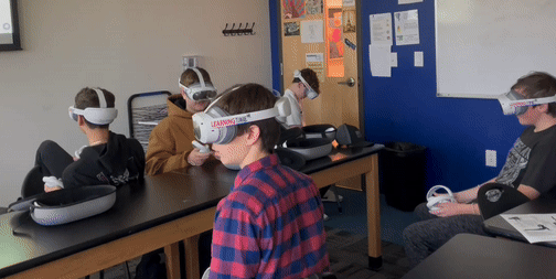 Students receiving support with VR headsets